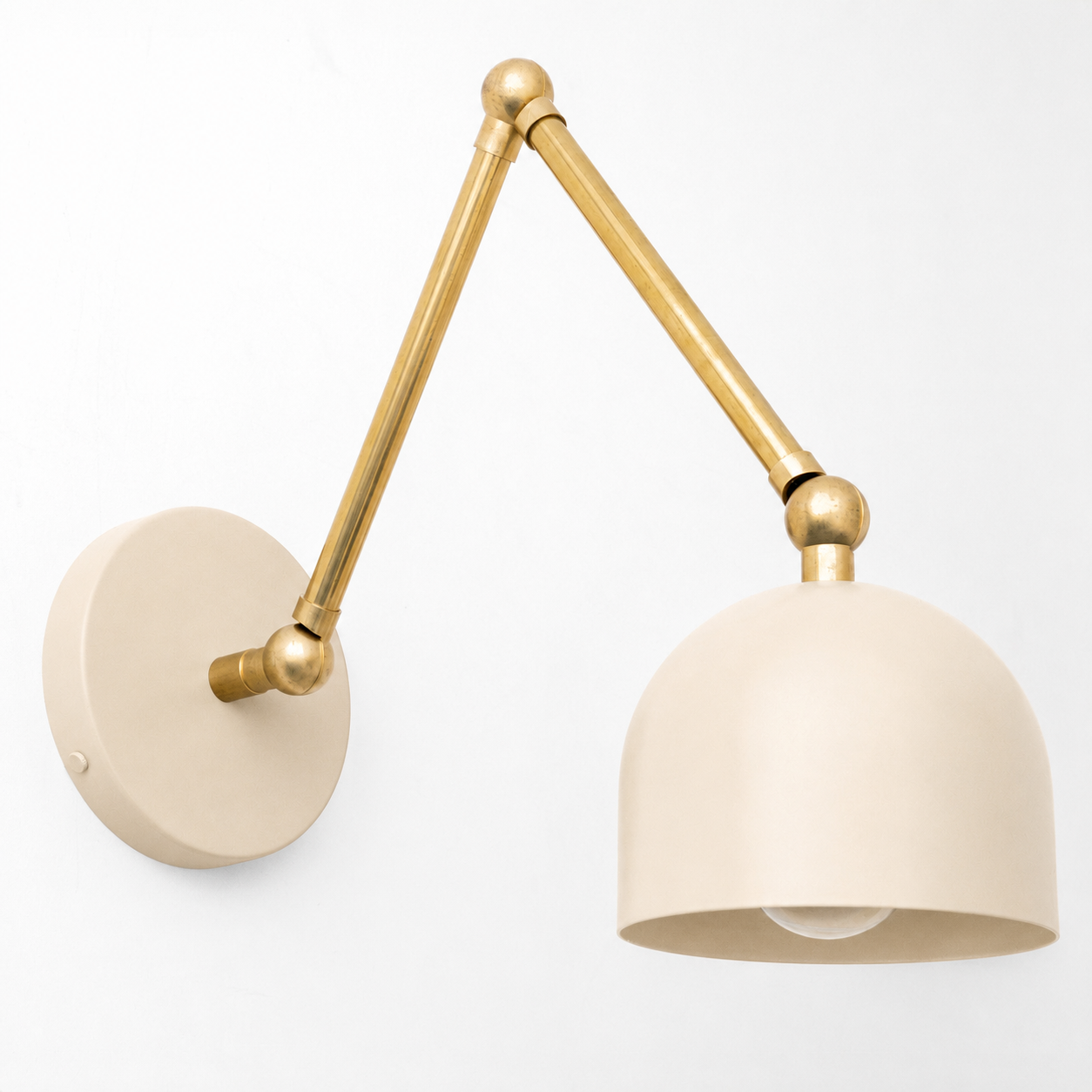 Adjustable wall sconce with matte beige dome shade and brass arm mounted on round beige base. - SCONCE MODEL NO. 5998