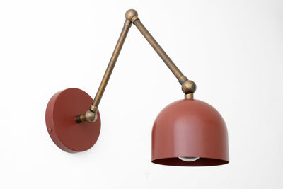 Matte red adjustable metal wall sconce with dome shade and antique brass arm. - SCONCE MODEL NO. 5998