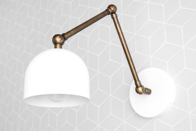 Industrial adjustable wall sconce with matte white dome shade and brass finish arm and mounting plate. - SCONCE MODEL NO. 5998