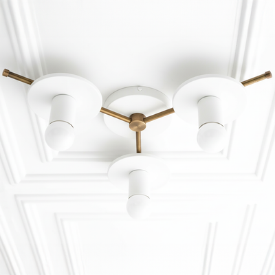 Mid-century modern chandelier with three white cylindrical shades and antique brass arms and base flush mounted on ceiling. - CHANDELIER MODEL NO. 9526