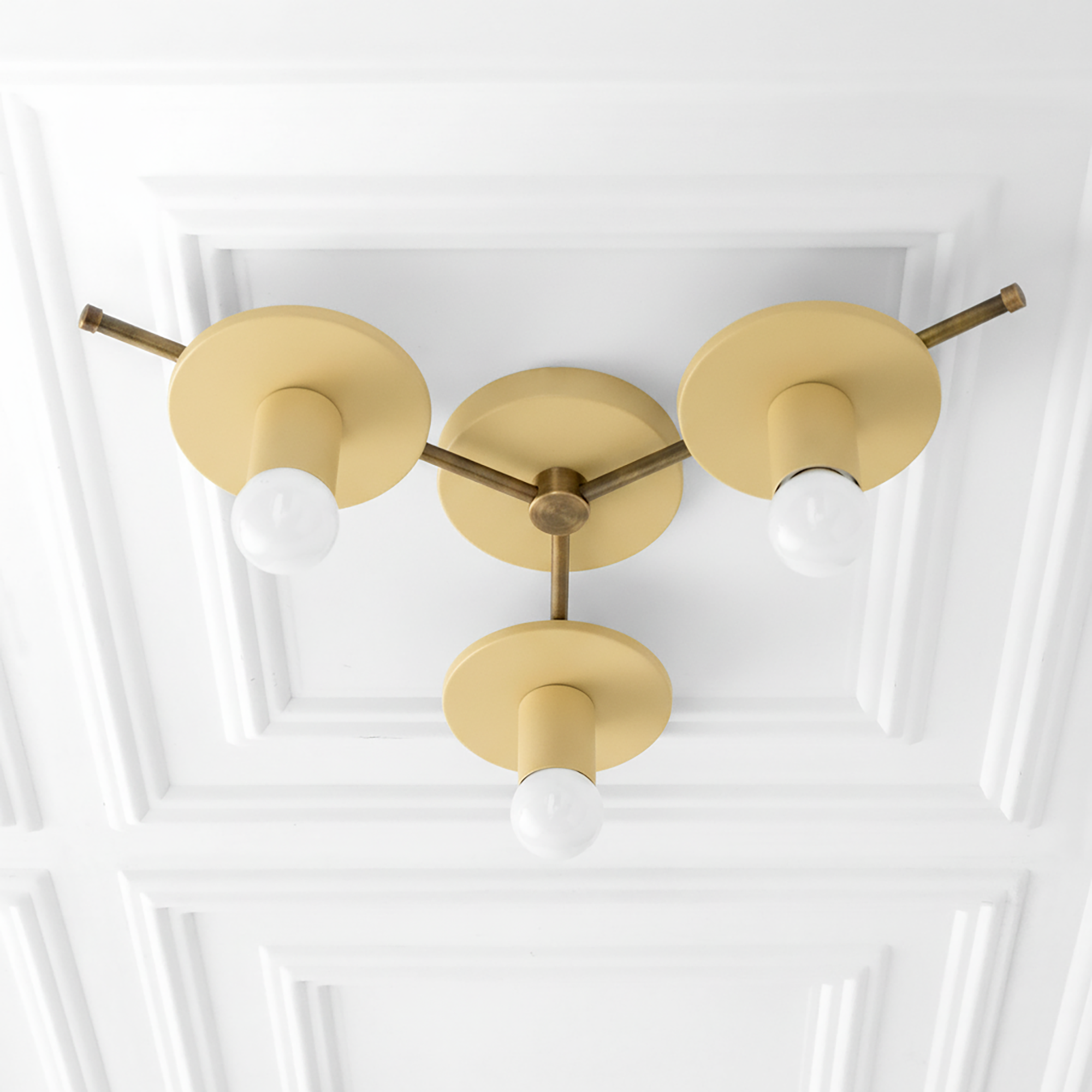 Mid-century modern flush mount chandelier with three matte yellow shades and exposed bulbs on antique brass arms. - CHANDELIER MODEL NO. 9526