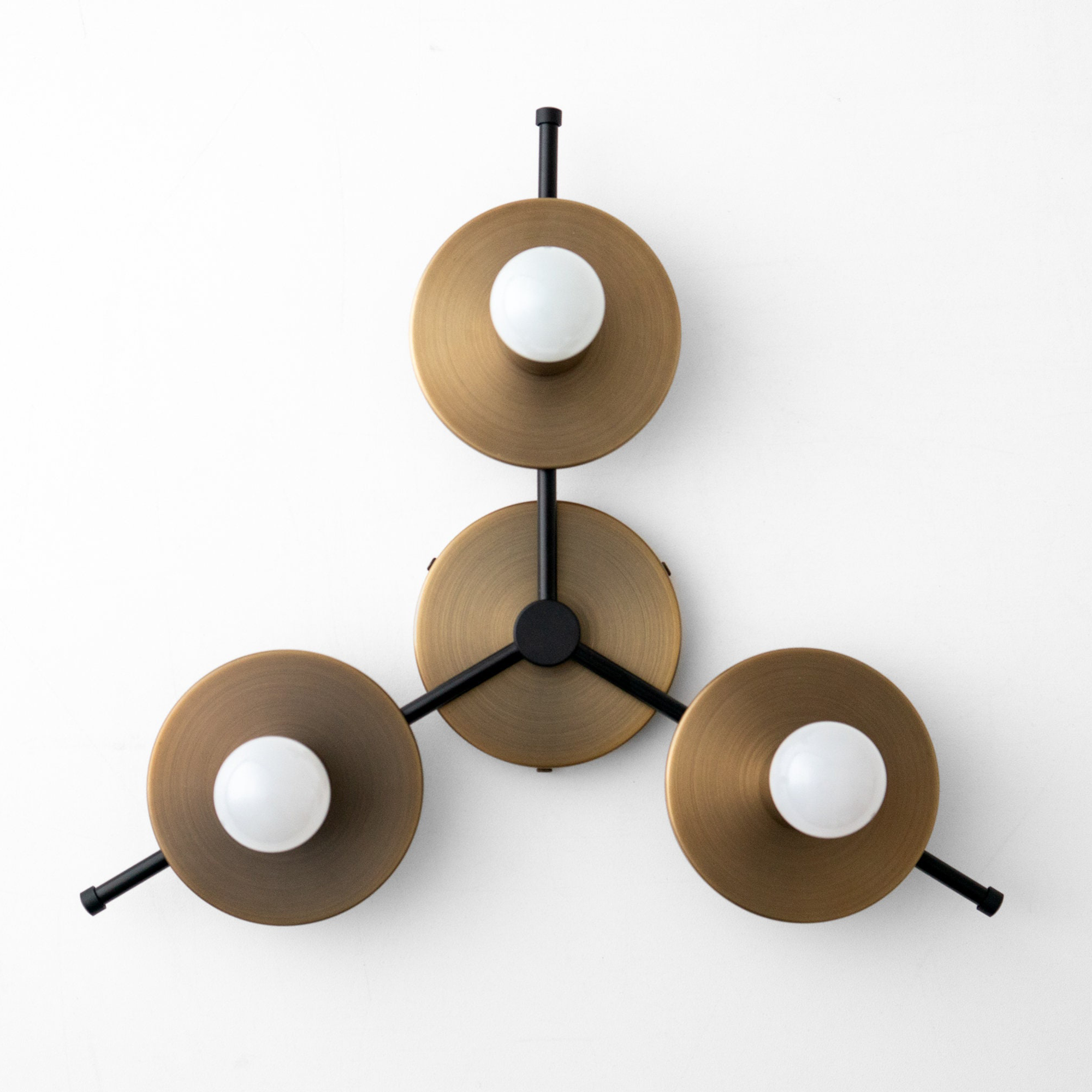 Mid-century modern flush mount chandelier with three raw brass circular shades and black arms. - CHANDELIER MODEL NO. 9526