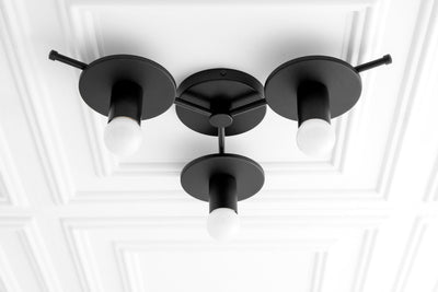 Black flush mount ceiling light with three exposed white bulbs arranged in a triangular mid-century modern design. - CHANDELIER MODEL NO. 9526