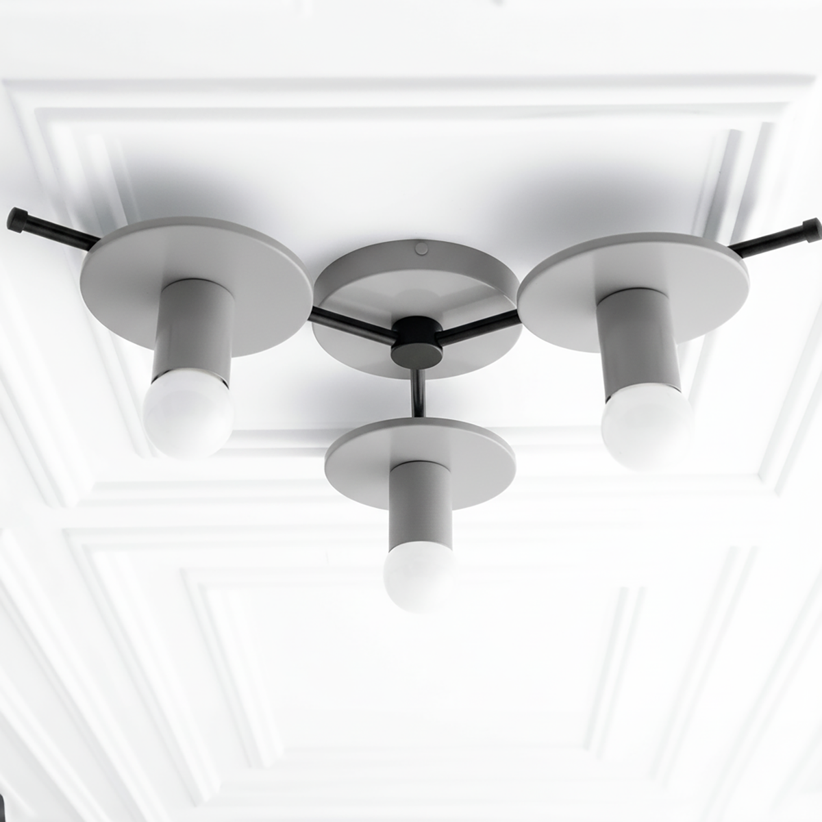 Flush mount chandelier with three matte gray cylindrical shades and matte black metal accents on white ceiling panel. - CHANDELIER MODEL NO. 9526