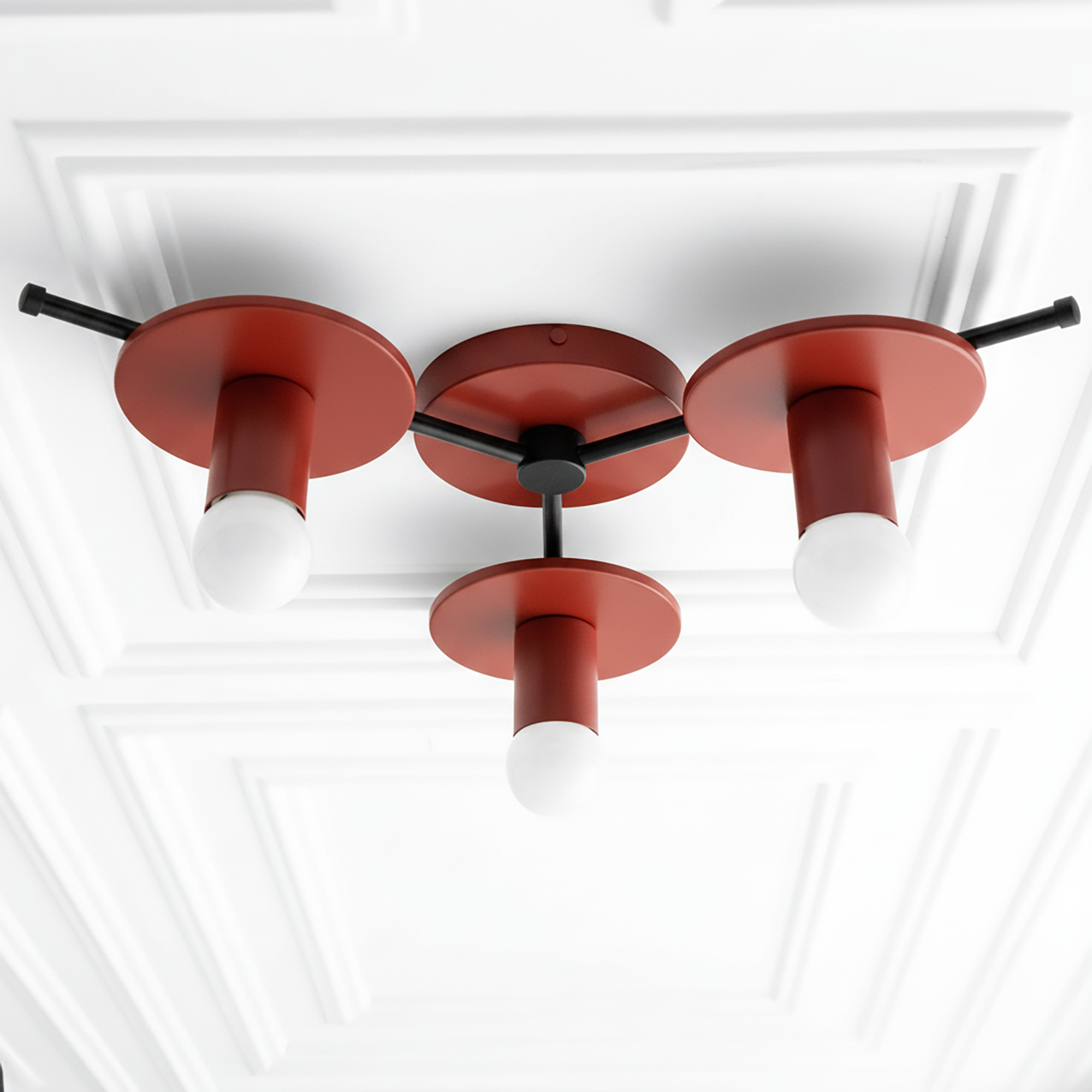 Mid-century modern flush mount ceiling light with three exposed white bulbs and red circular metal shades on black arms. - CHANDELIER MODEL NO. 9526