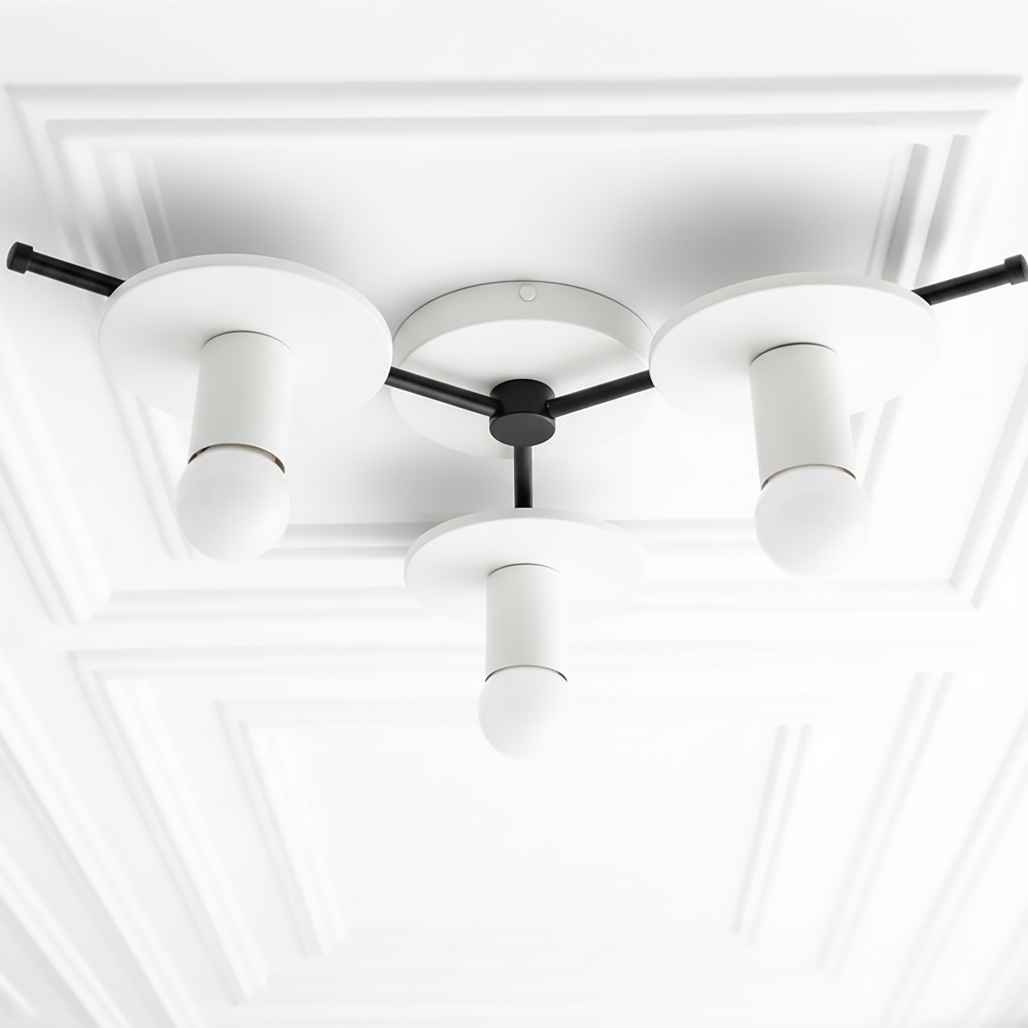 Mid-century modern flush mount chandelier with three white cylindrical shades and black fixtures on a white ceiling panel. - CHANDELIER MODEL NO. 9526
