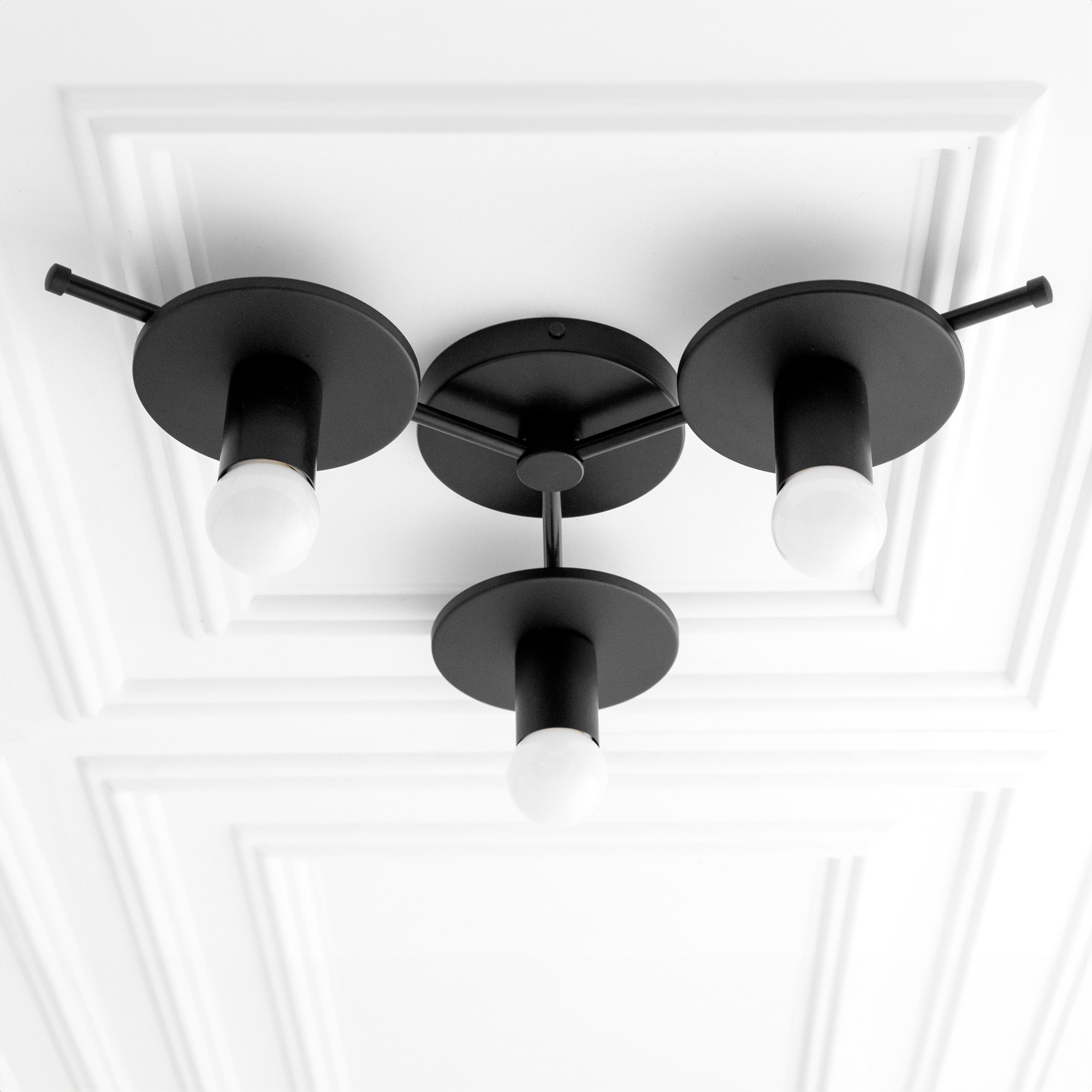 Black flush mount chandelier with three exposed bulb fixtures and round metal bases. - CHANDELIER MODEL NO. 9526