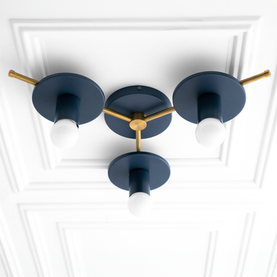 Mid-century modern flush mount chandelier with three exposed bulbs and matte navy blue arms connected by antique brass. - CHANDELIER MODEL NO. 9526