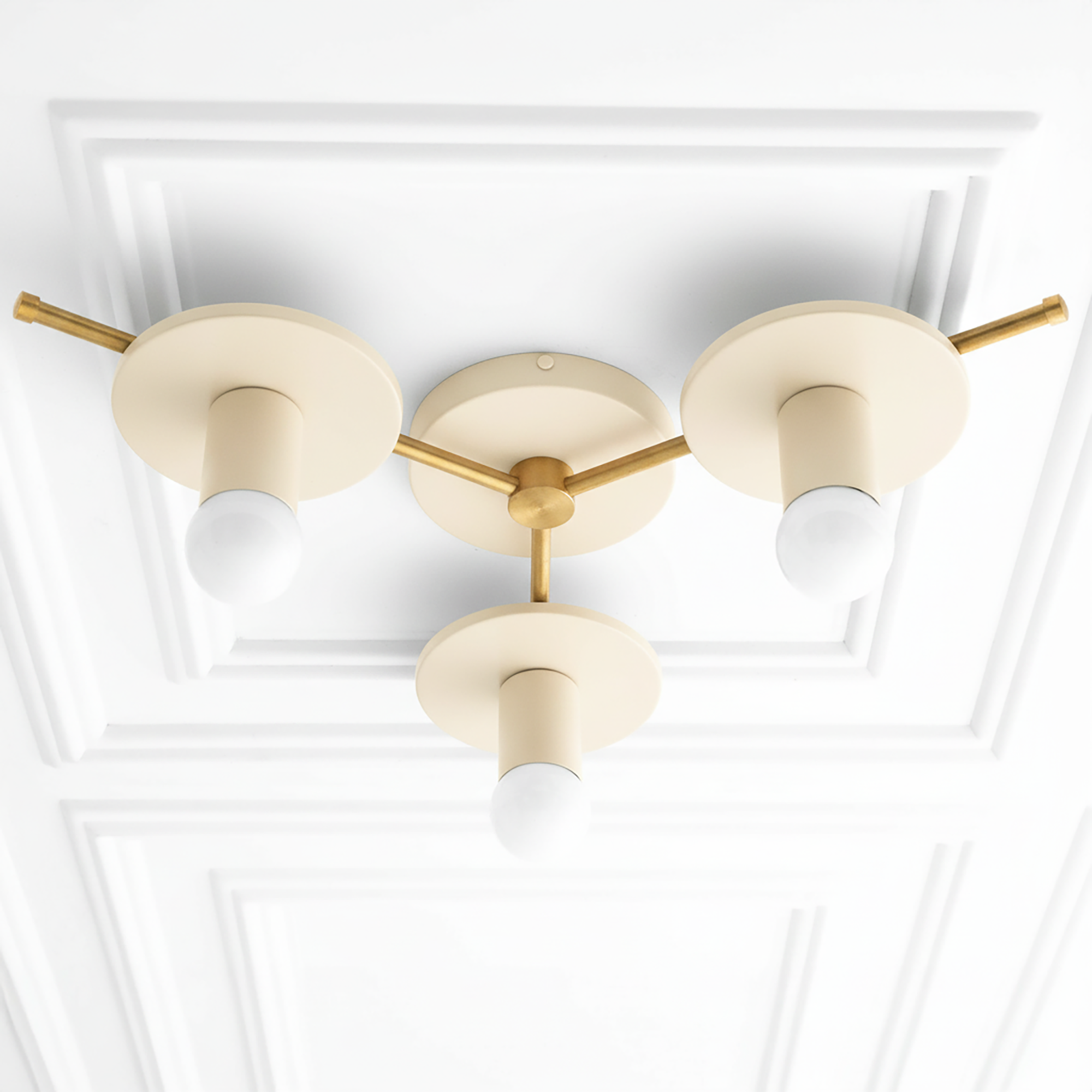 Mid-century modern flush mount chandelier with antique brass rods and cream-colored round shades, three exposed bulbs. - CHANDELIER MODEL NO. 9526