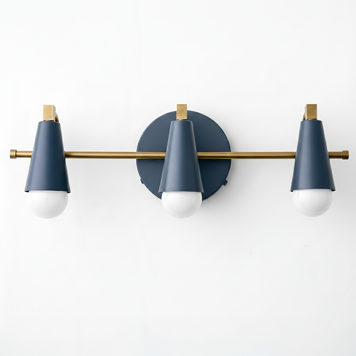 Three-light vanity fixture with matte navy blue cone shades and brushed brass horizontal bar and accents. - VANITY LIGHT MODEL NO. 8084