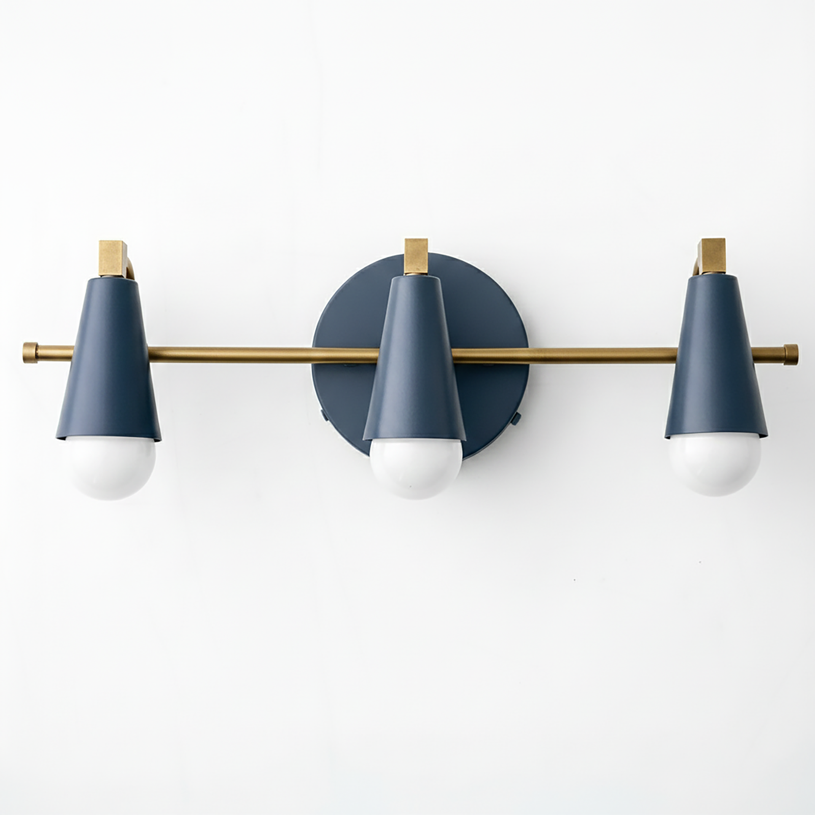 Three-light vanity fixture with matte navy blue cone shades and brushed brass horizontal bar and accents. - VANITY LIGHT MODEL NO. 8084
