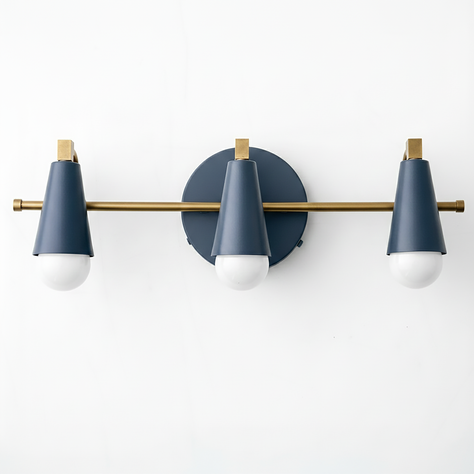 Three-light vanity fixture with matte navy blue cone shades and brushed brass horizontal bar and accents. - VANITY LIGHT MODEL NO. 8084