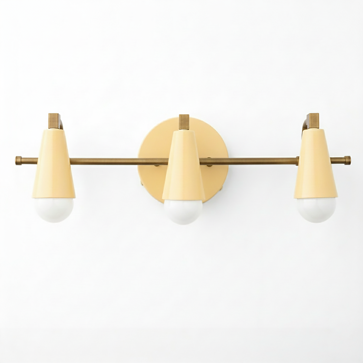 Three-light vanity fixture with conical cream shades and brass horizontal bar mounting on round brass backplate. - VANITY LIGHT MODEL NO. 8084