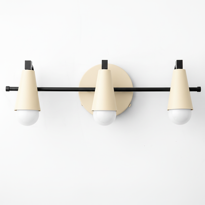 Three-light vanity fixture with matte cream conical shades and black metal accents on a circular wall mount. - VANITY LIGHT MODEL NO. 8084