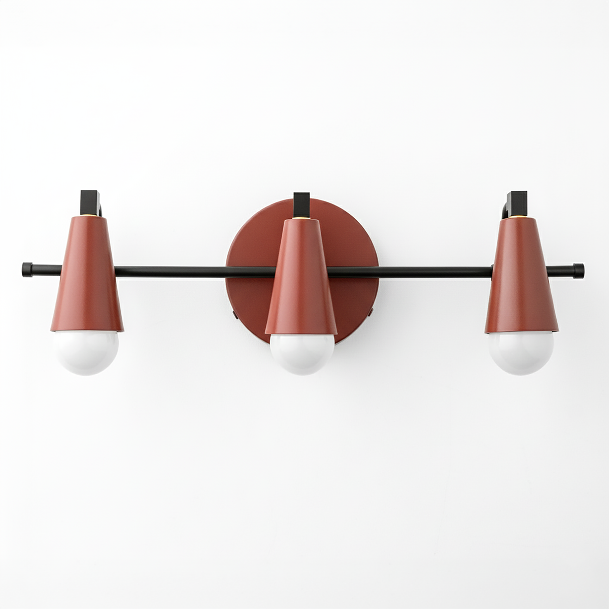 Three-light vanity fixture with matte black horizontal rod and rust-red conical metal shades over white round bulbs. - VANITY LIGHT MODEL NO. 8084