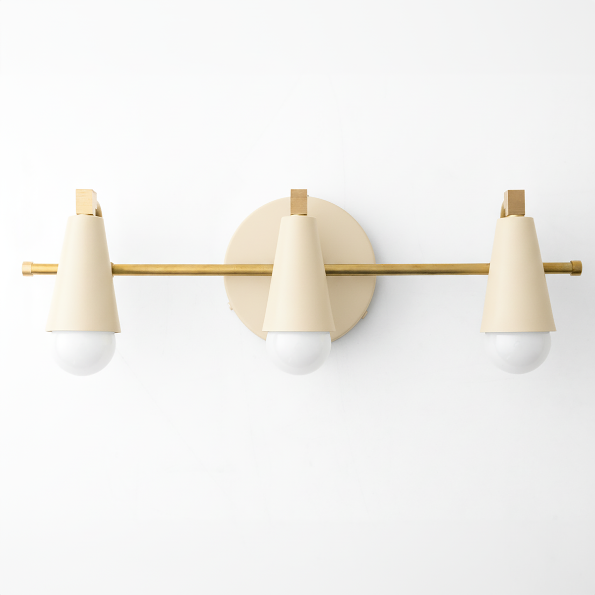 Mid-century modern vanity light with three cone-shaped cream shades and brass rod mounting. - VANITY LIGHT MODEL NO. 8084