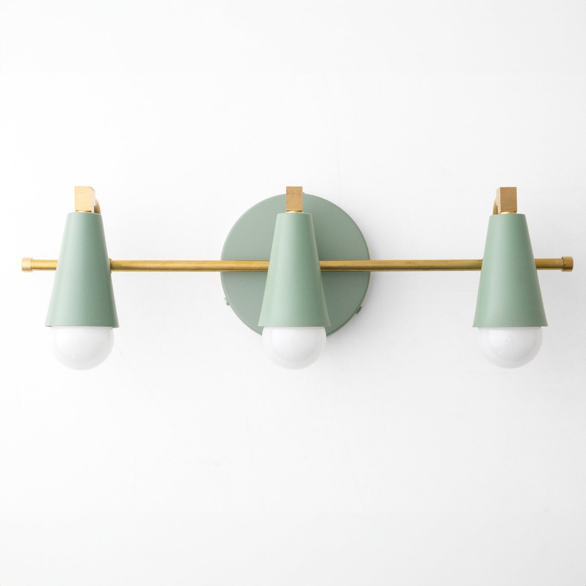 Mid-century modern vanity light with three conical matte green metal shades and brass accents on a horizontal brass bar. - VANITY LIGHT MODEL NO. 8084