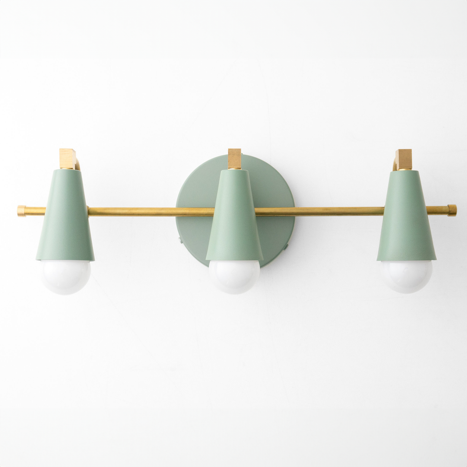 Mid-century modern vanity light with three conical matte green metal shades and brass accents on a horizontal brass bar. - VANITY LIGHT MODEL NO. 8084