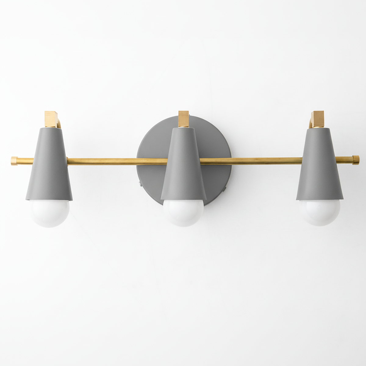 Mid-century modern 3-bulb vanity light with matte gray cone shades and brass accents on a round gray base. - VANITY LIGHT MODEL NO. 8084