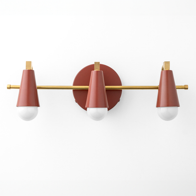 Industrial-style vanity light with three cone-shaped matte red metal shades and brass accents on a round wall mount. - VANITY LIGHT MODEL NO. 8084