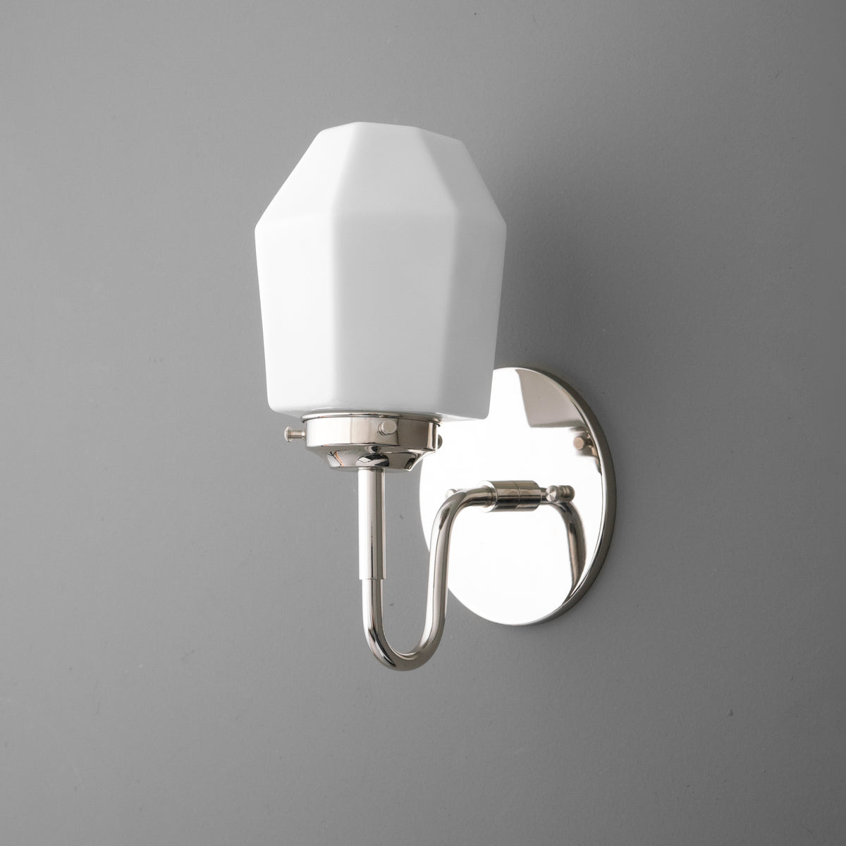 Polished chrome 1-bulb wall sconce with faceted white glass shade and curved arm mount. - SCONCE MODEL NO. 1038
