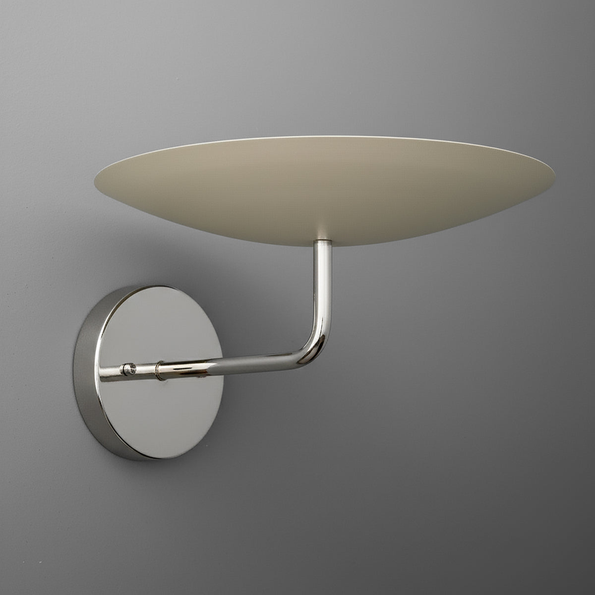 Modern wall sconce with a round chrome base, curved arm, and a flat, wide beige shade. - SCONCE MODEL NO. 1504