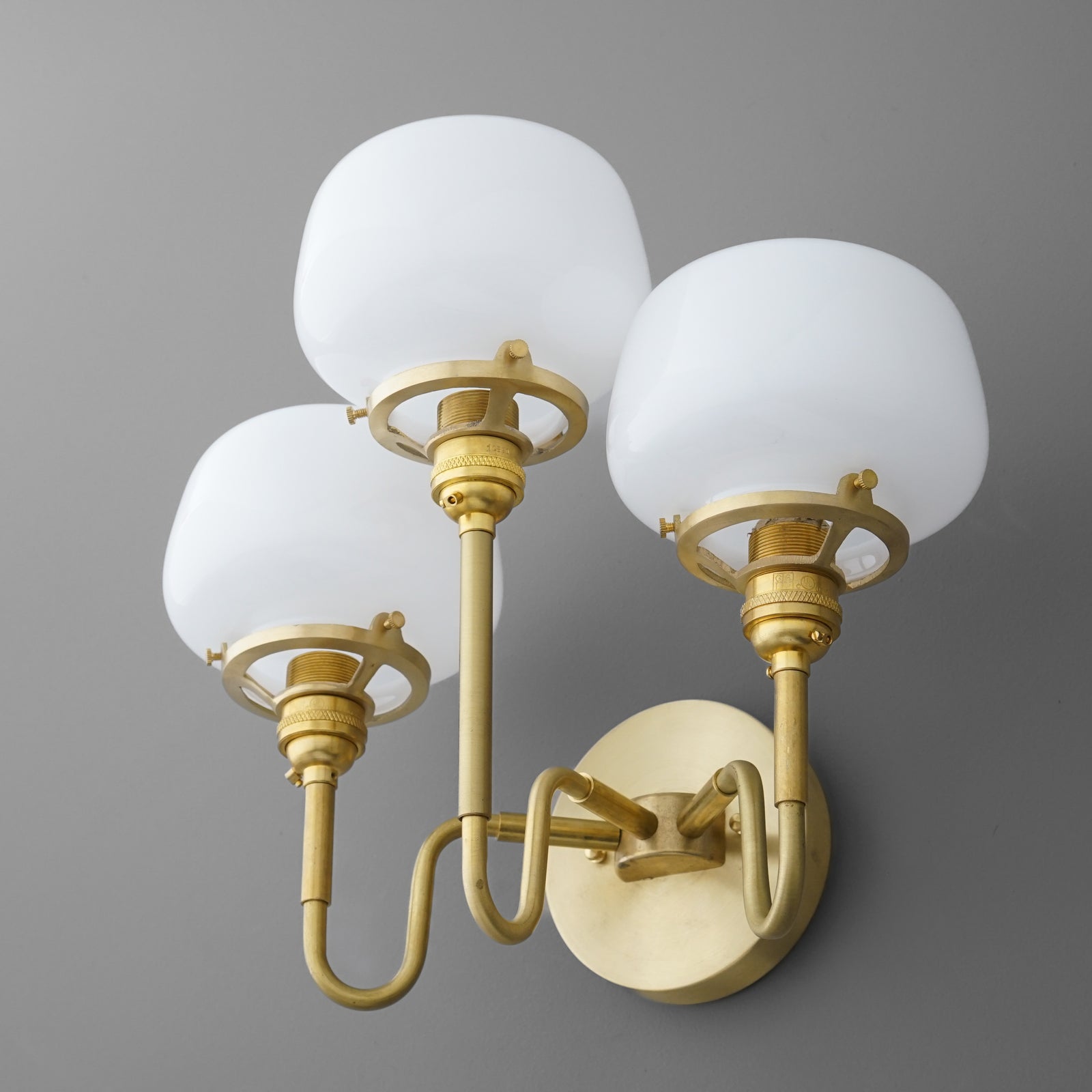 Three-bulb wall sconce with frosted white glass globes and brushed gold metal arms and base. - SCONCE MODEL NO. 8654