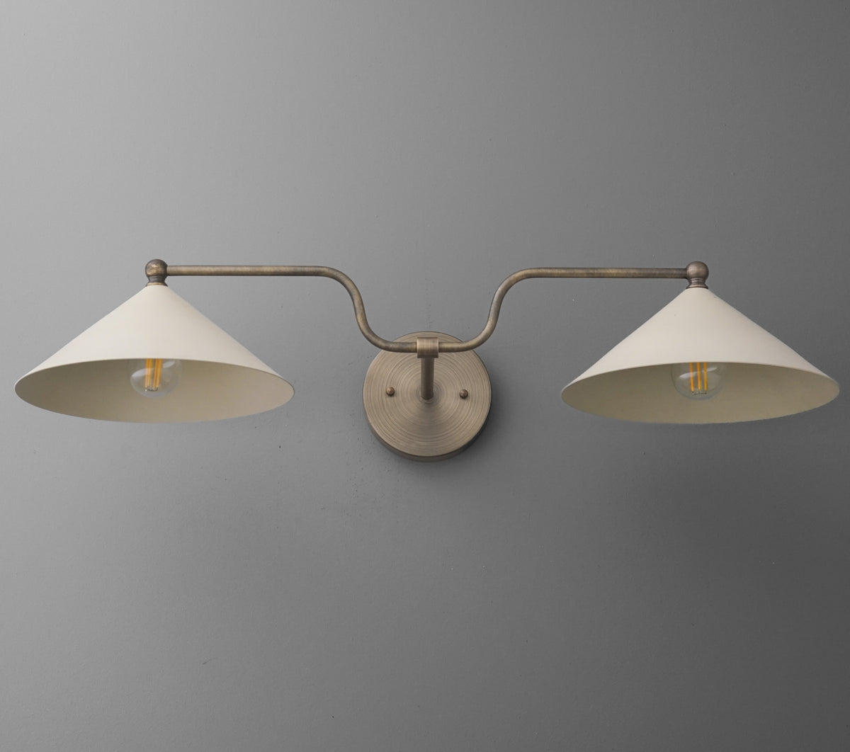 Two-light vanity fixture with matte beige conical shades and brushed metal arms mounted on circular base. - VANITY LIGHT MODEL NO. 1171