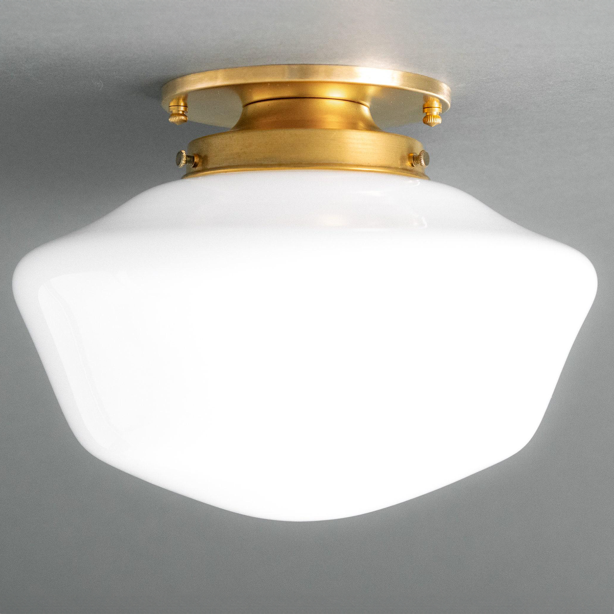 Flush mount ceiling light with a curved white glass globe and brass finish base in Art Deco style. - CEILING LIGHT MODEL NO. 4340