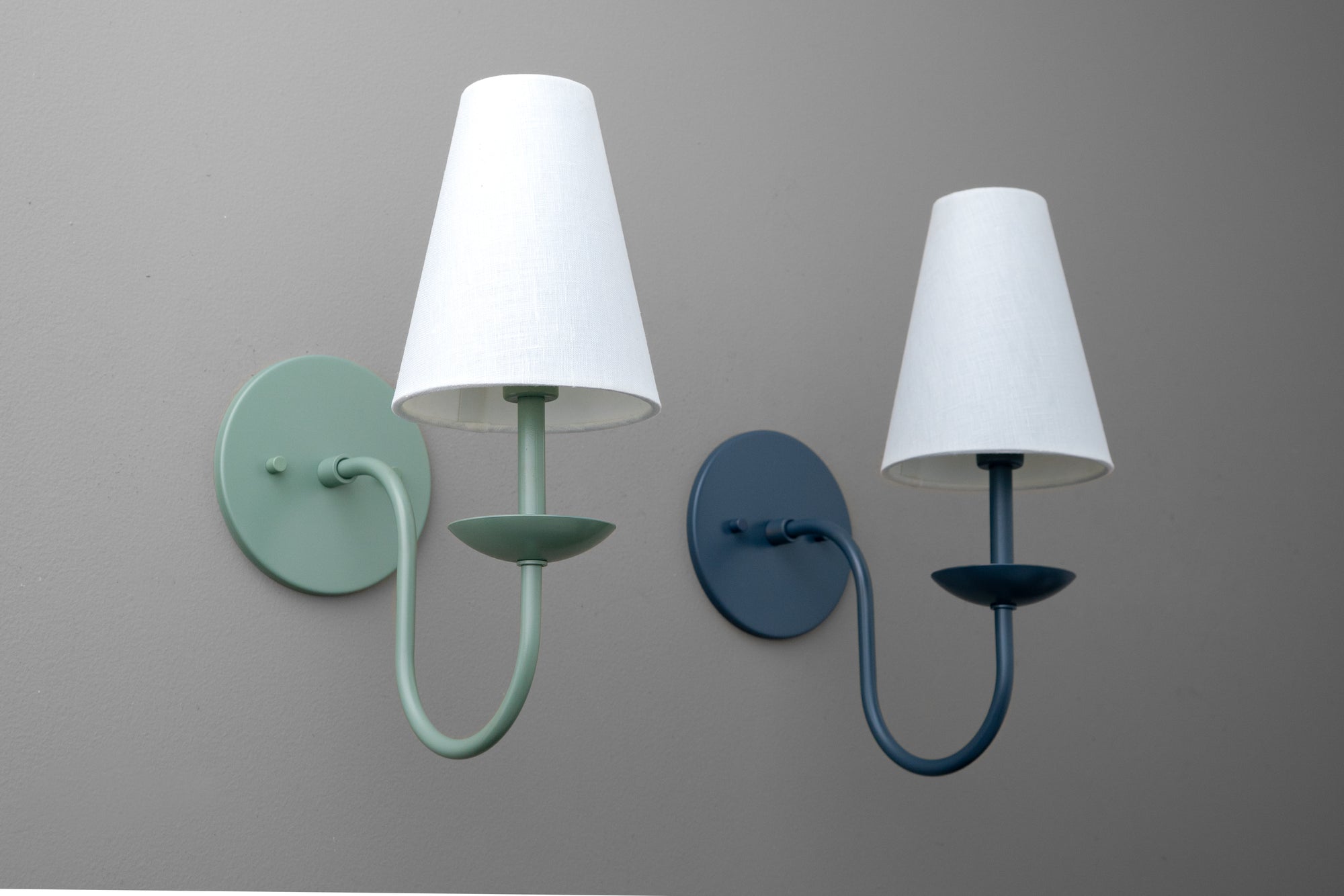 Pair of wall sconces with cone-shaped white shades in matte teal and navy blue metal finishes. - SCONCE MODEL NO. 7085