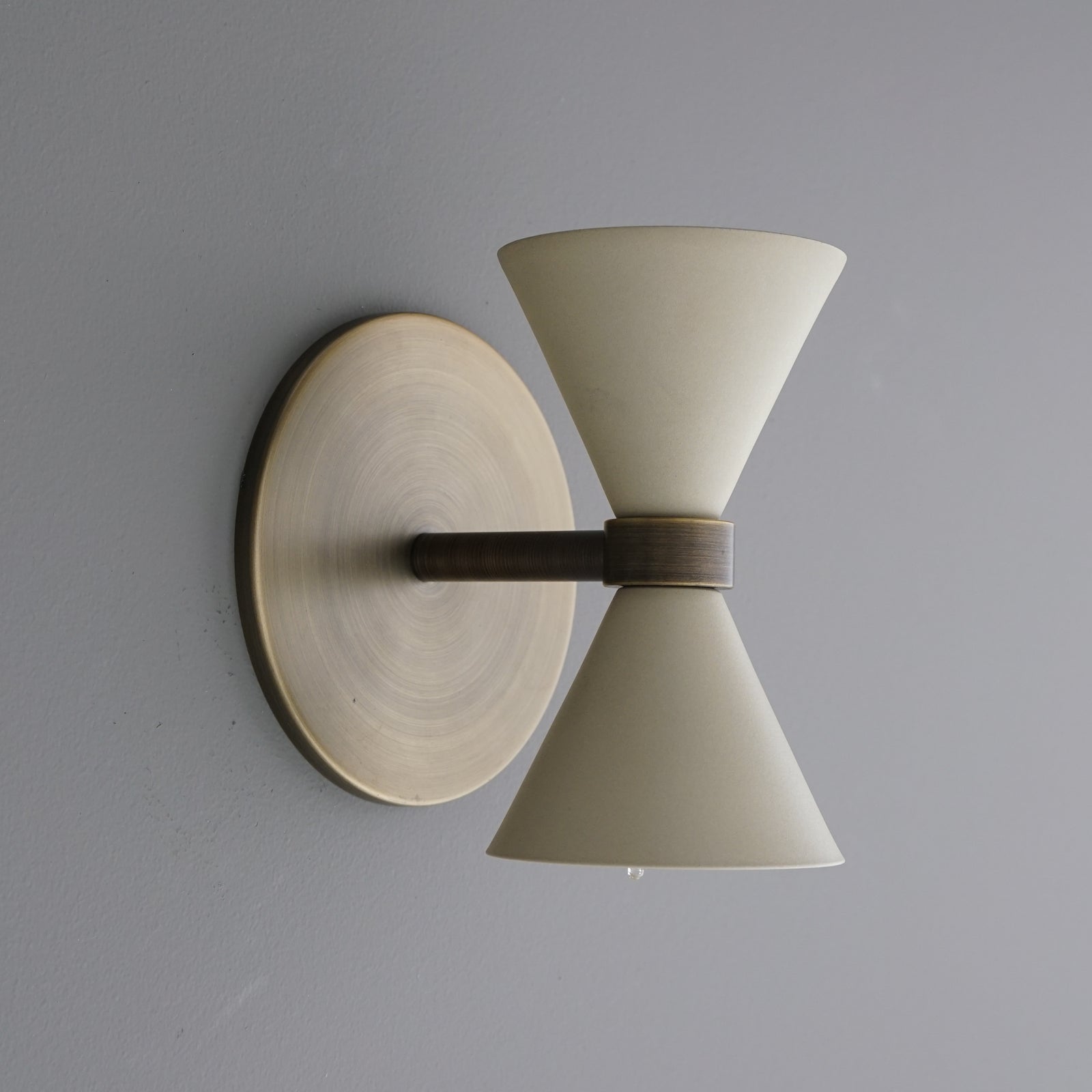 Brushed brass wall sconce with hourglass-shaped frosted glass shades and dark metal center band. - SCONCE MODEL NO. 5143