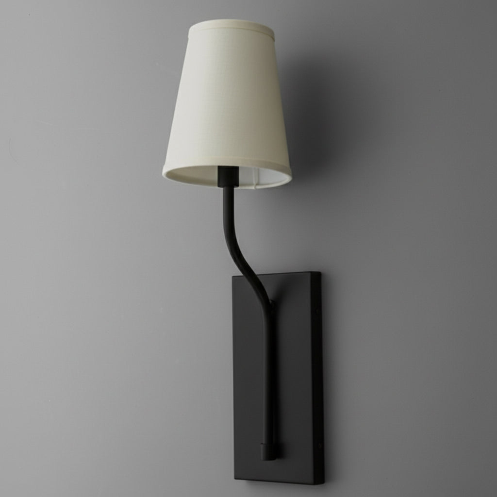 Black metal wall sconce with curved arm and white fabric tapered lampshade on rectangular backplate. - SCONCE MODEL NO. 9714