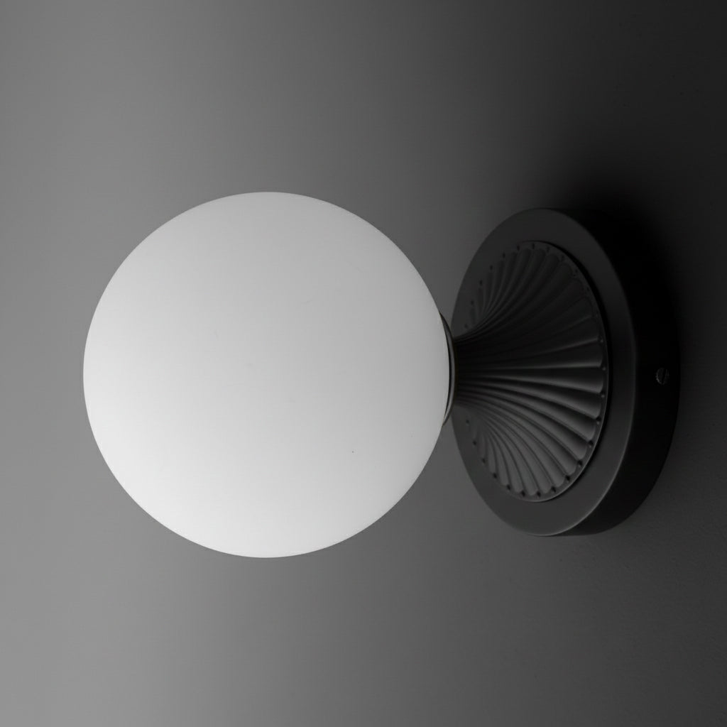 Black metal wall sconce with round ribbed base and large white frosted glass globe shade. - SCONCE MODEL NO. 5936