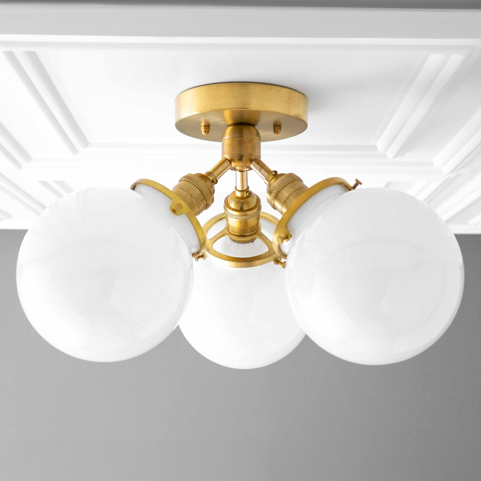 Mid-century modern flush mount ceiling light with three white glass globes and raw brass fixtures. - CEILING LIGHT MODEL NO. 0210