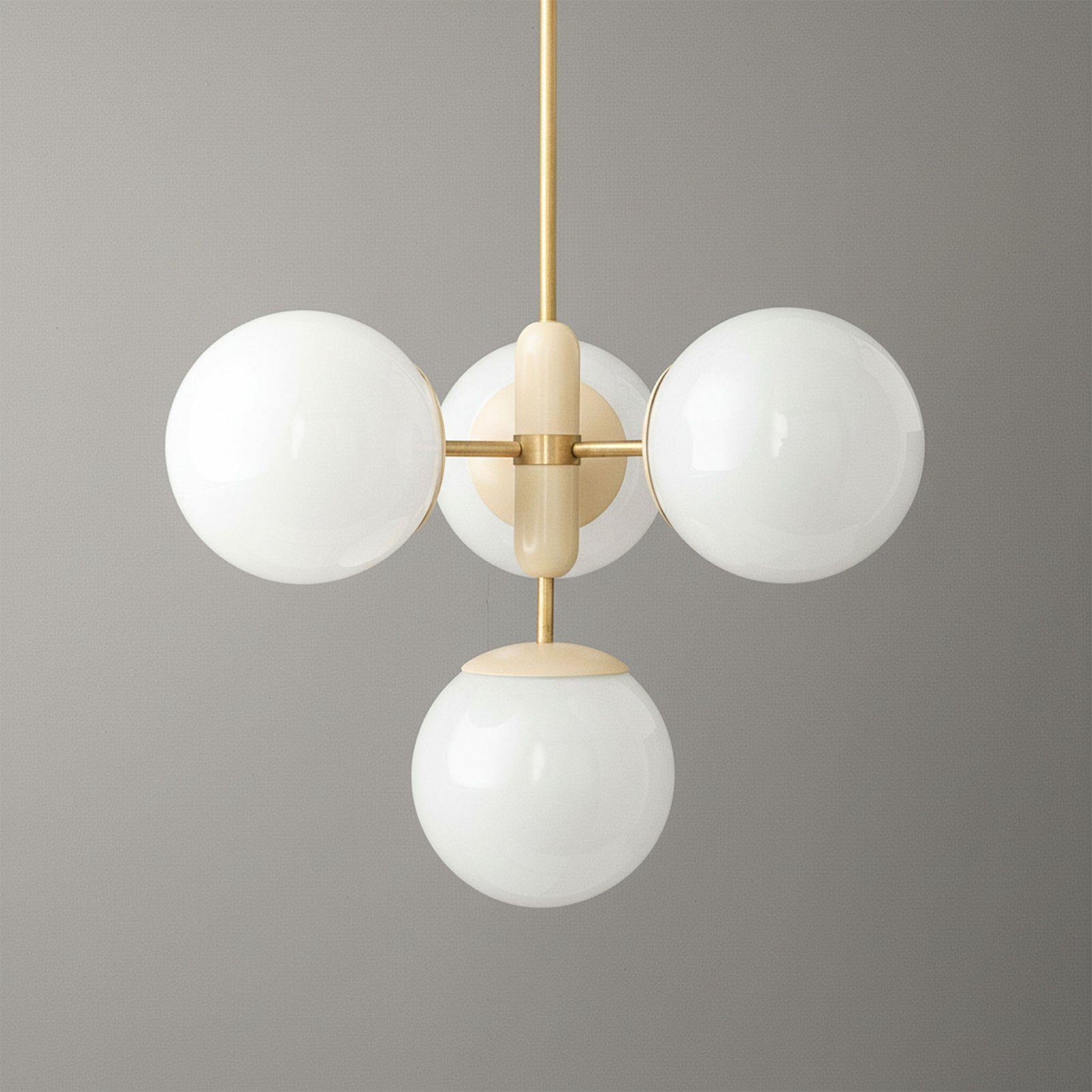 Art Deco chandelier with sealed brass frame and four white glass globes against gray background. - CHANDELIER MODEL NO. 4321