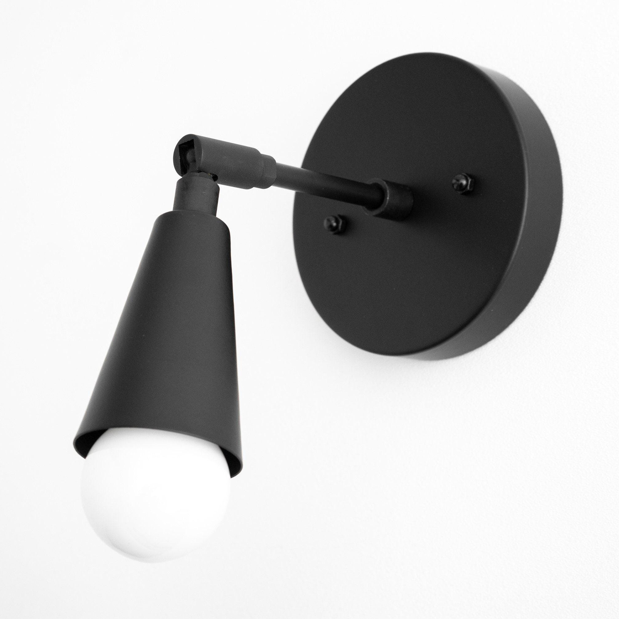 Matte black mid-century modern adjustable sconce with exposed bulb and round wall mount. - SCONCE MODEL NO. 4339
