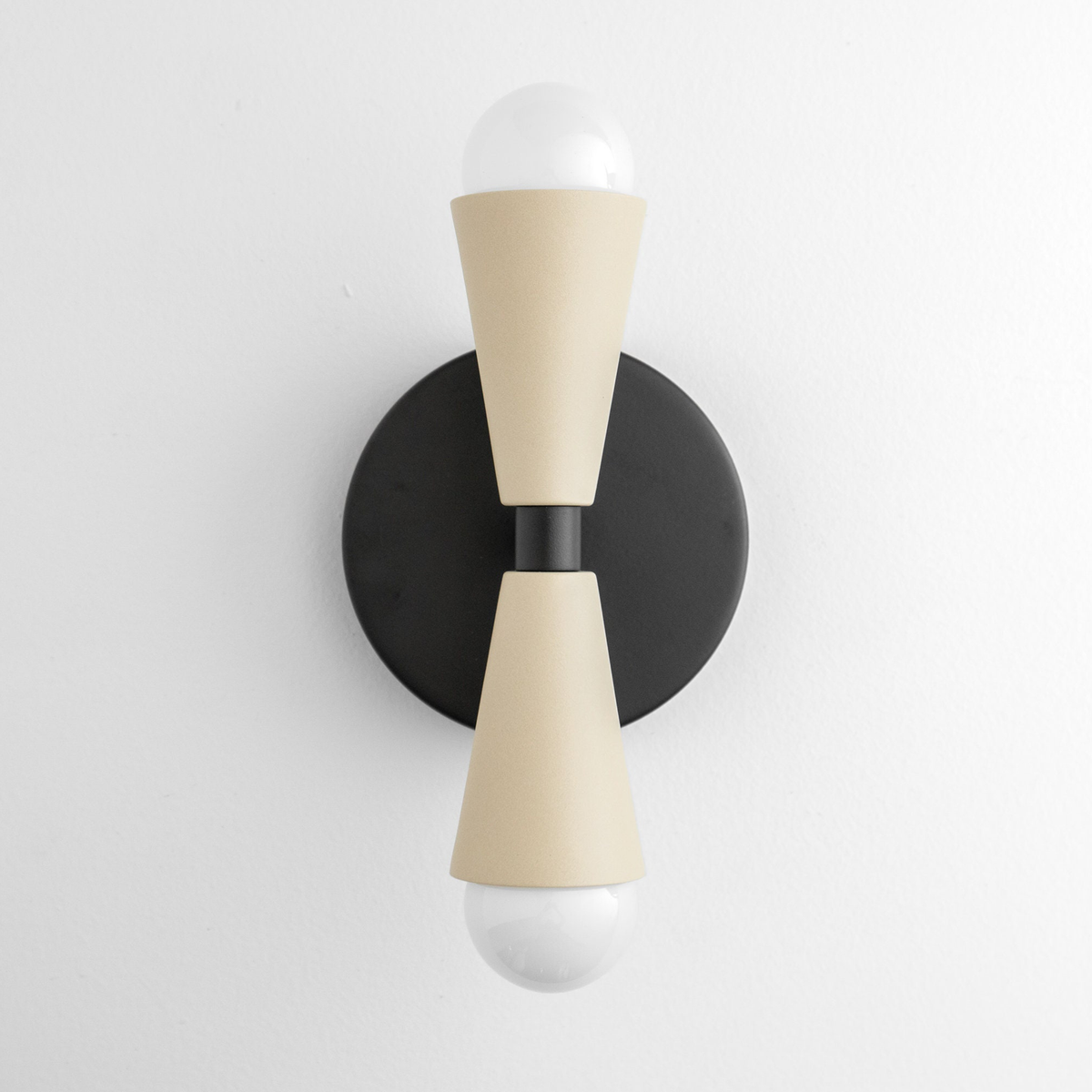 Modern up/down wall sconce with matte black round base and cream tapered shades covering bulbs. - SCONCE MODEL NO. 4717