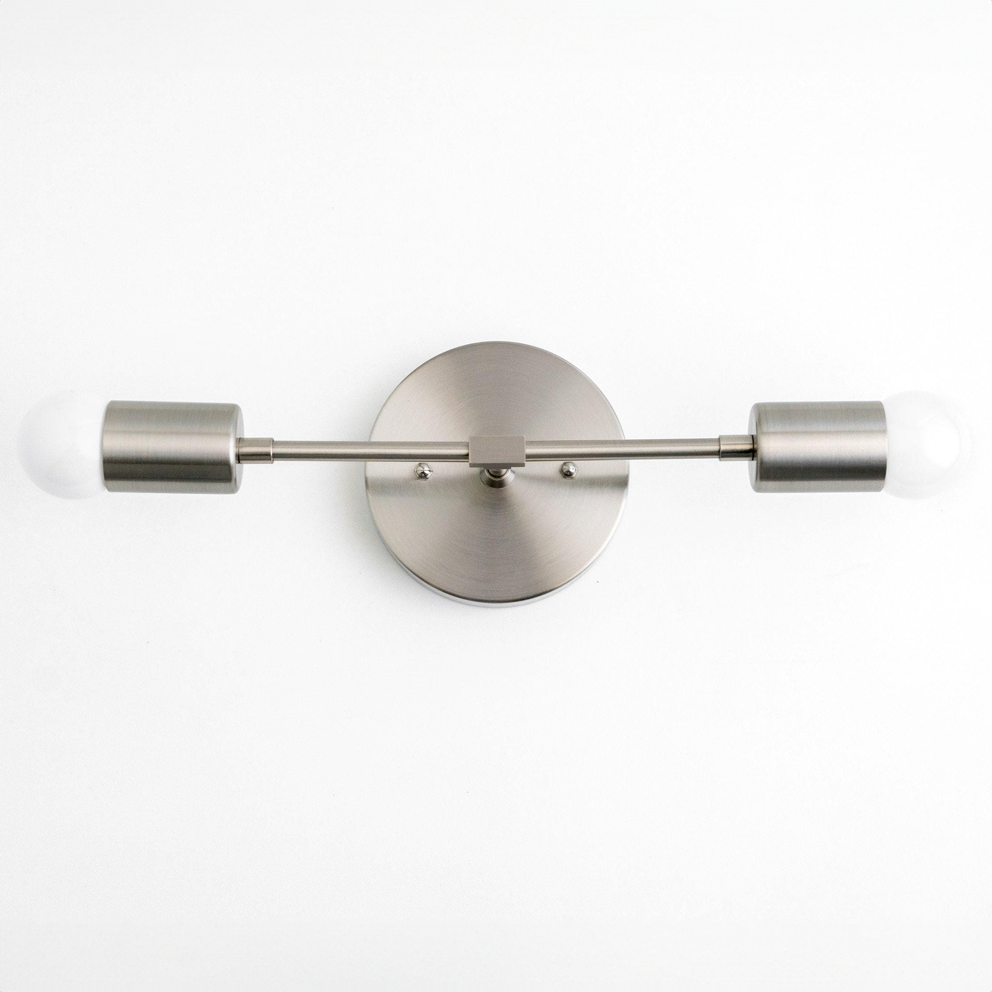 Mid-century modern 2-bulb vanity light in brushed nickel with exposed round bulbs. - VANITY LIGHT MODEL NO. 5563