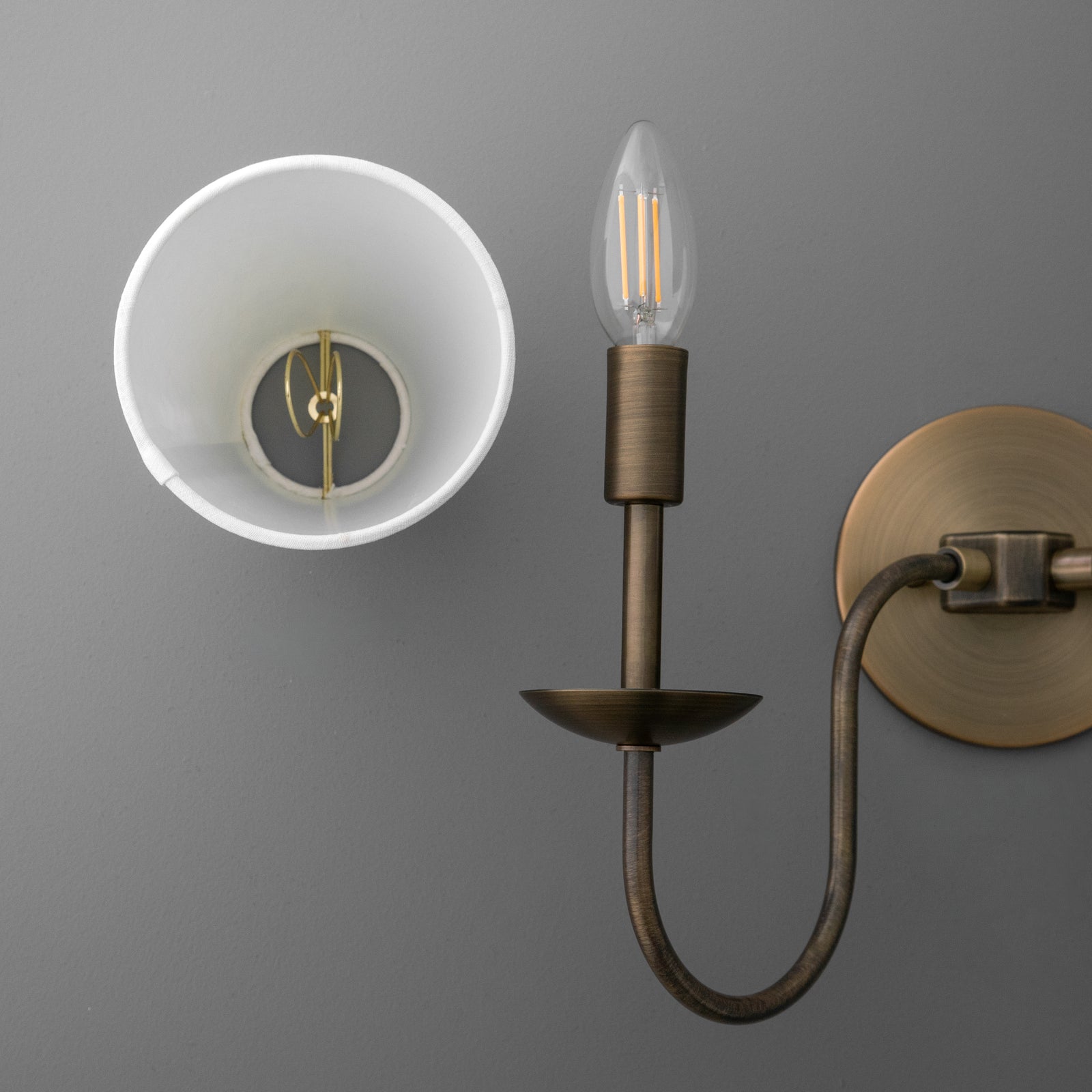 Antique brass 2-bulb wall sconce with curved arm and exposed filament bulbs. - SCONCE MODEL NO. 5846