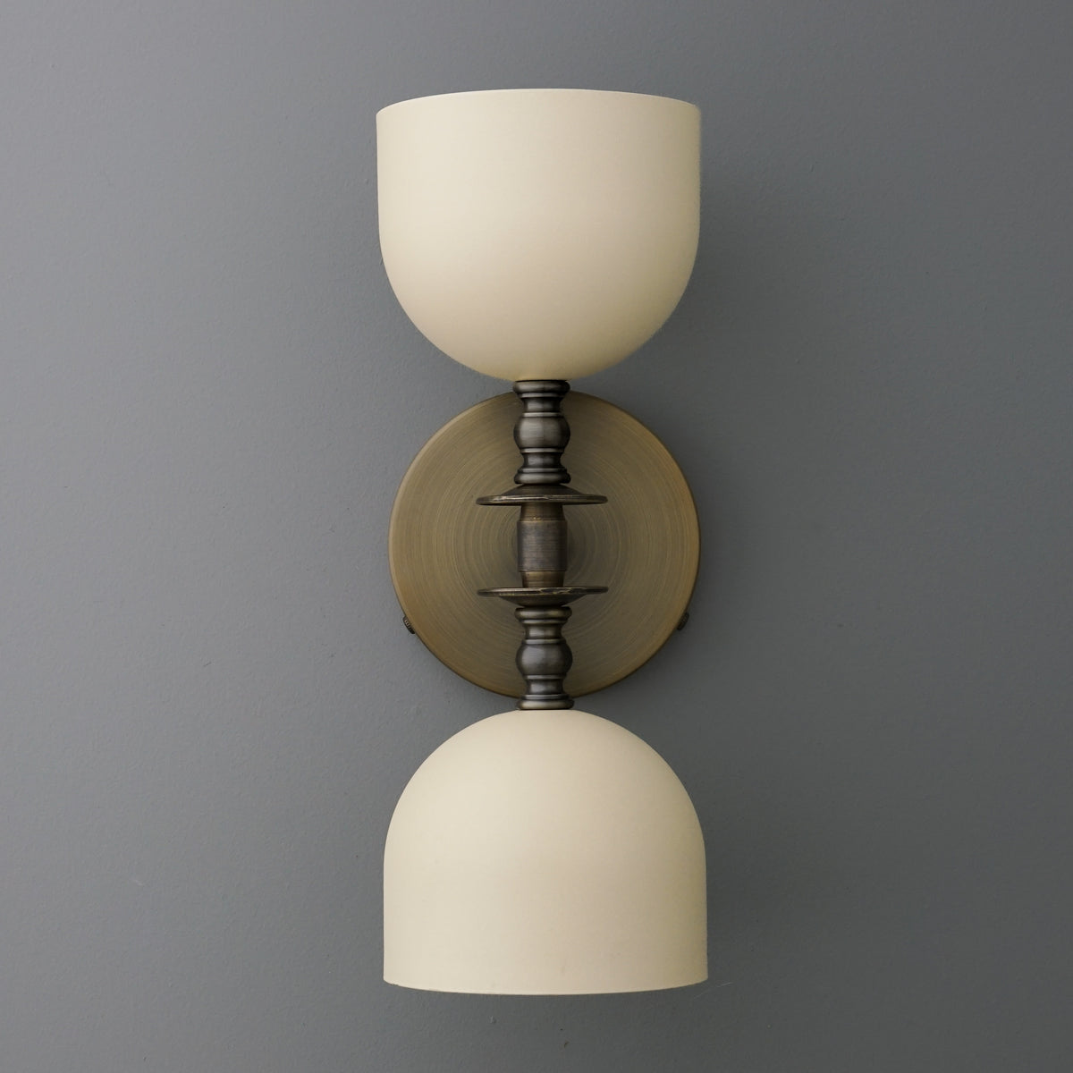Wall sconce with two frosted white glass shades and antique bronze finish metal fixtures. - SCONCE MODEL NO. 6995