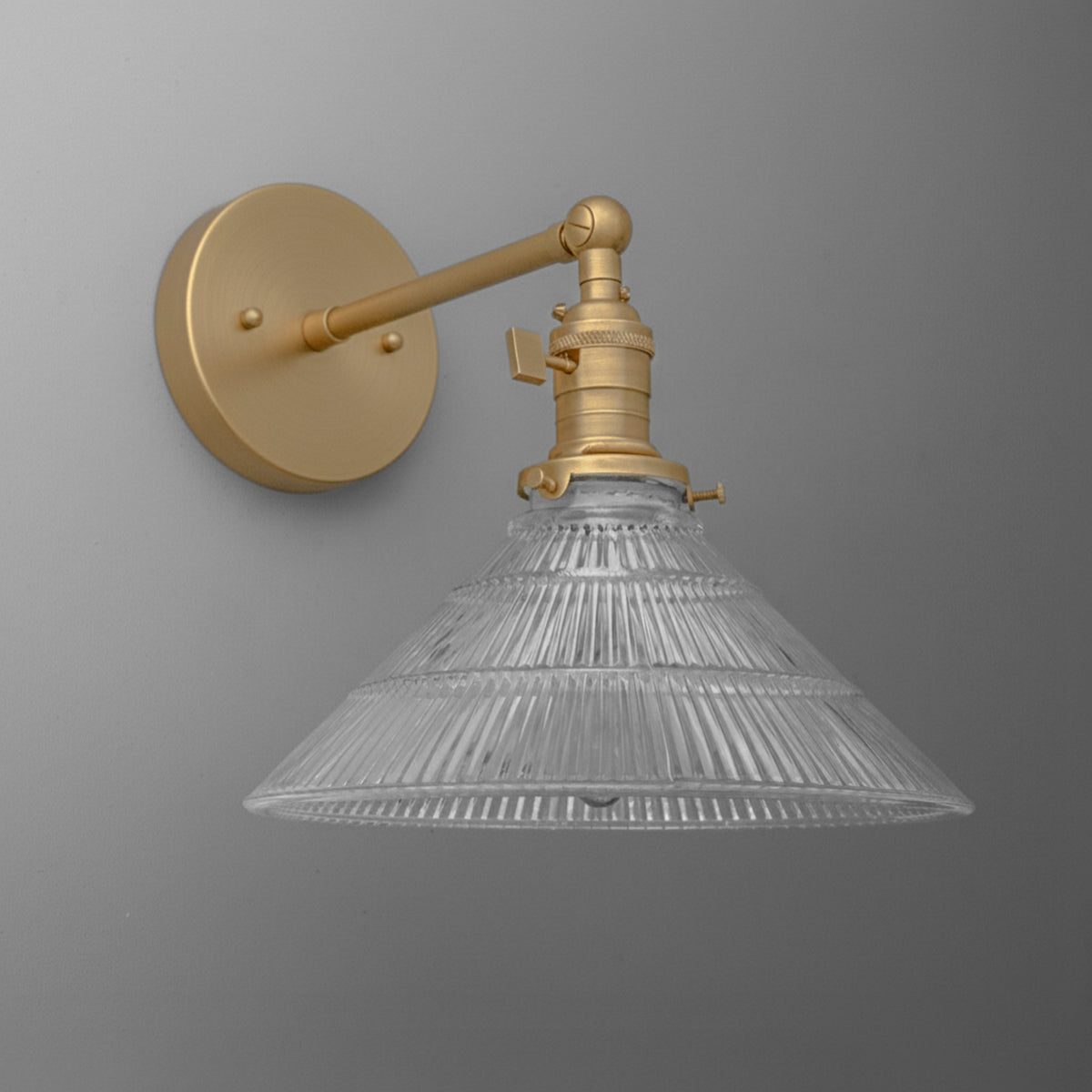 Wall-mounted single-bulb sconce with brass finish and ribbed clear glass conical shade. - SCONCE MODEL NO. 3170