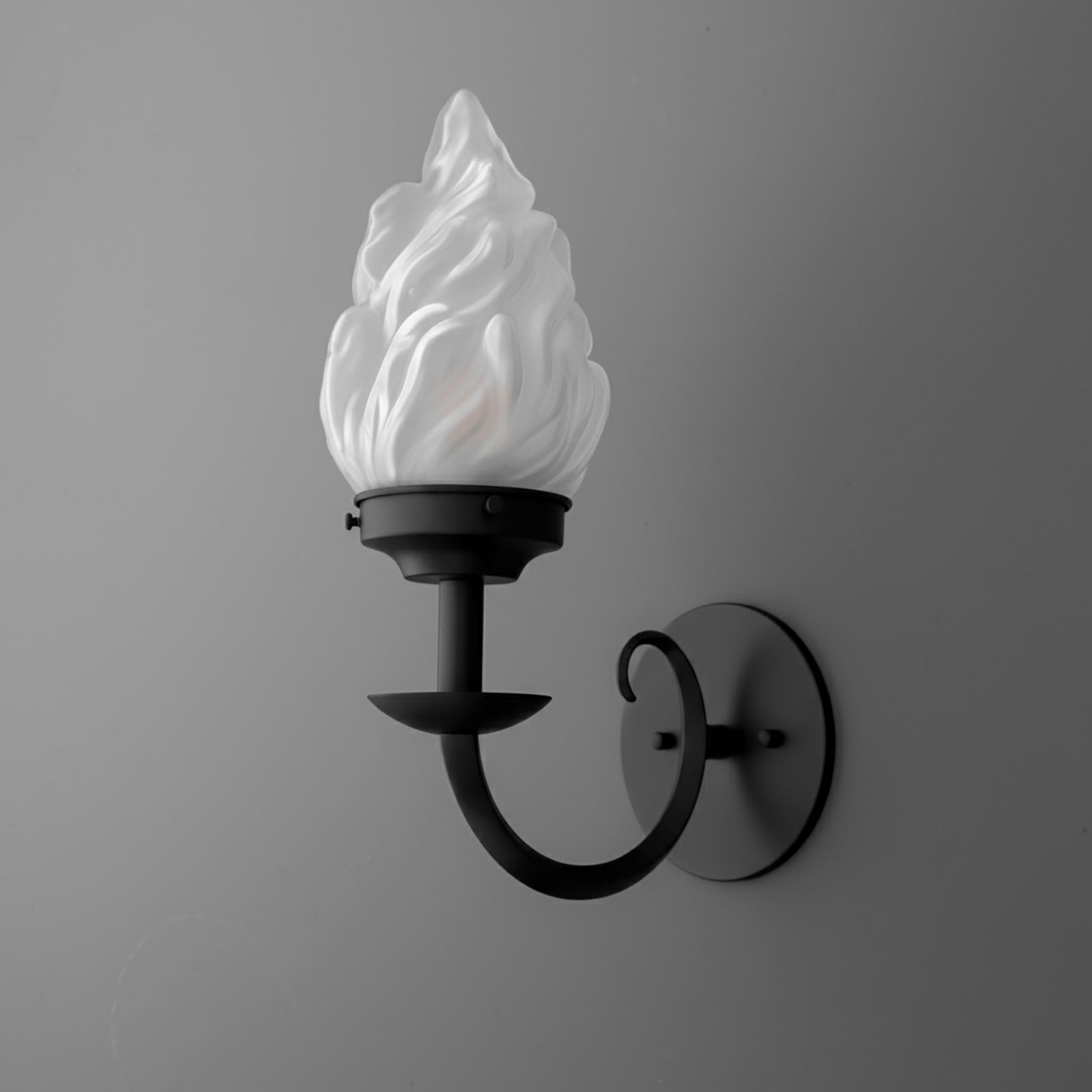 Black metal wall sconce with a curved arm and white frosted glass shade shaped like a flame. - SCONCE MODEL NO. 1057