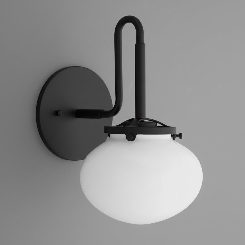 Black metal wall sconce with curved arm and frosted white glass globe shade. - SCONCE MODEL NO. 9452