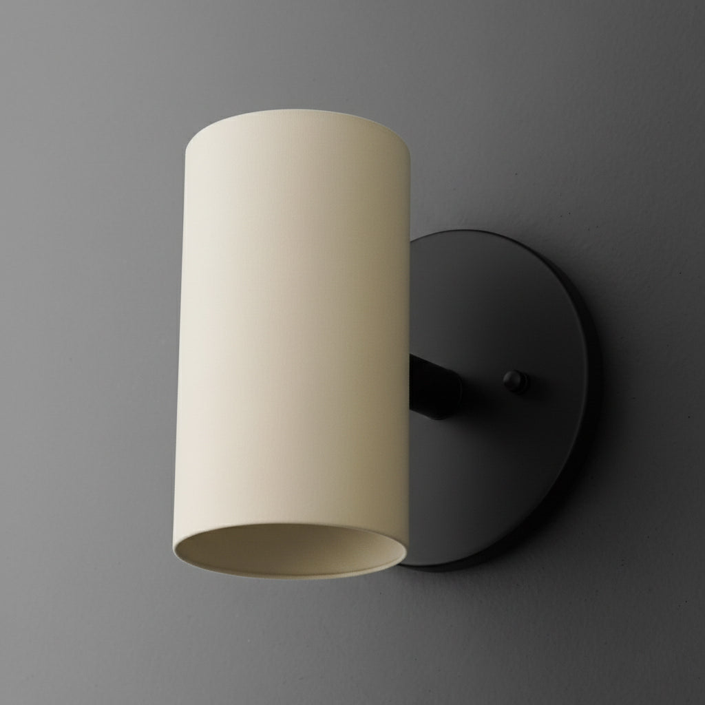 Cylinder sconce with a Cream shade on a short stem from a Black round wall plate. - SCONCE MODEL NO. 9697