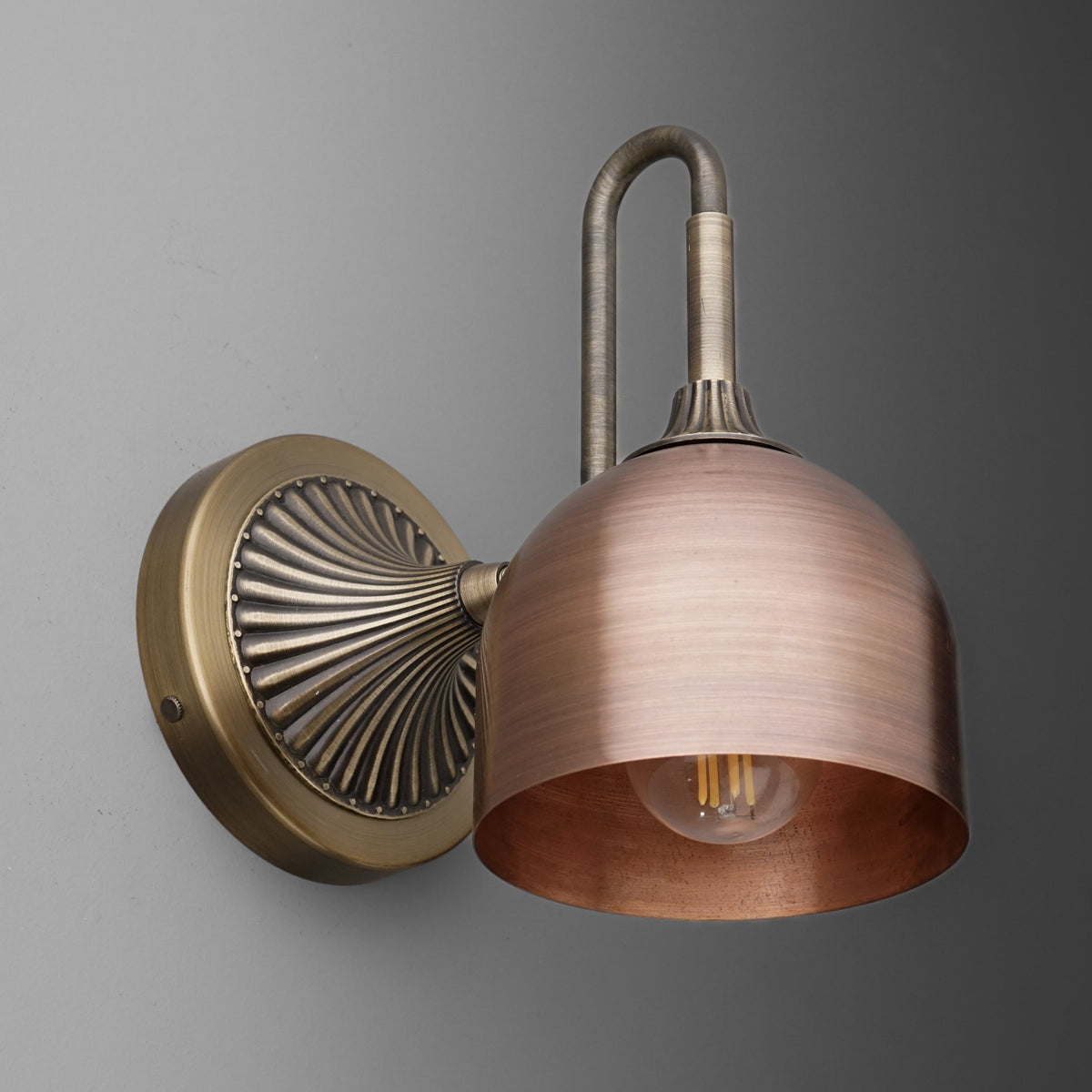 Antique brass wall sconce with a flared, brushed copper dome shade and exposed bulb. - SCONCE MODEL NO. 3046