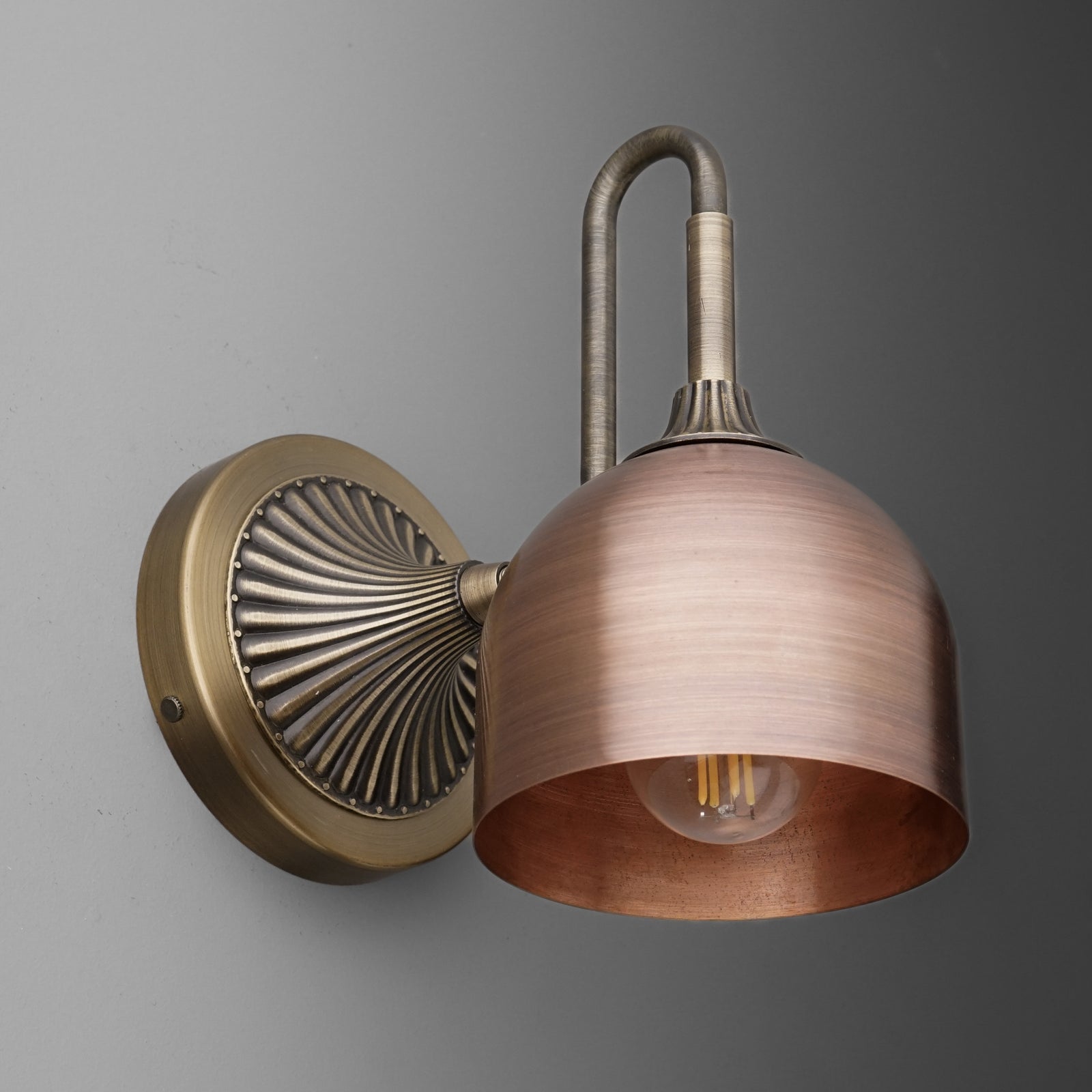 Antique brass wall sconce with a flared, brushed copper dome shade and exposed bulb. - SCONCE MODEL NO. 3046