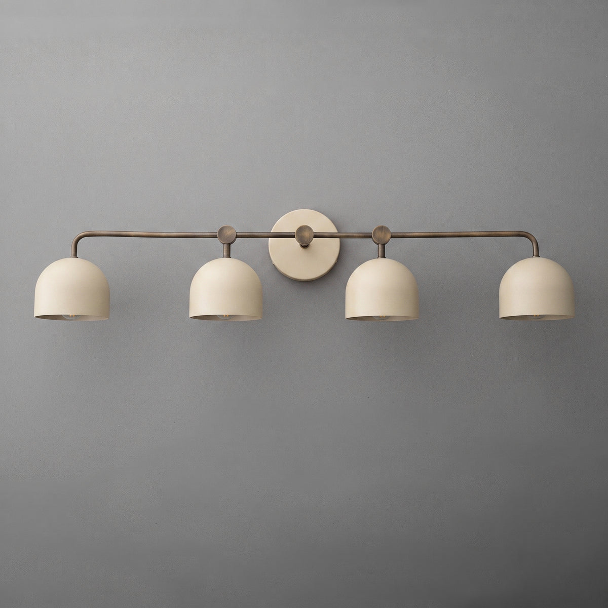 Four-light vanity light in Antique Brass with Cream dome shades and a matching Cream wall plate. - VANITY LIGHT MODEL NO. 1124