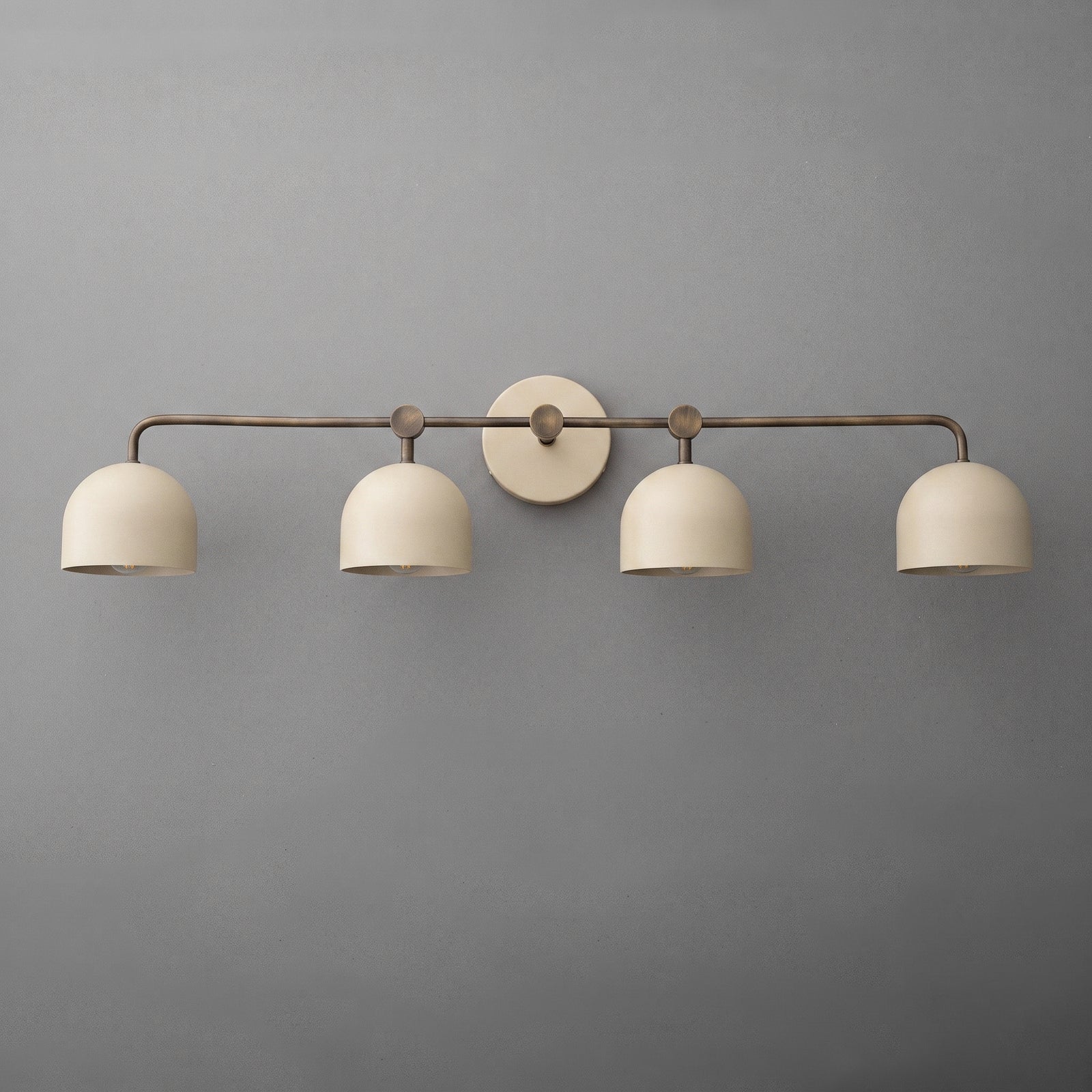 Four-light vanity light in Antique Brass with Cream dome shades and a matching Cream wall plate. - VANITY LIGHT MODEL NO. 1124