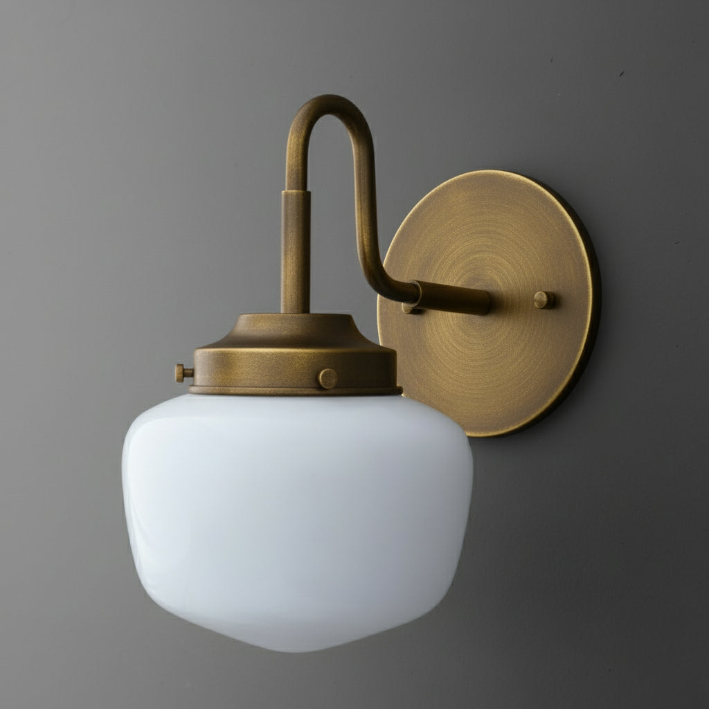 Antique brass wall sconce with curved arm and frosted white glass shade. - SCONCE MODEL NO. 1084