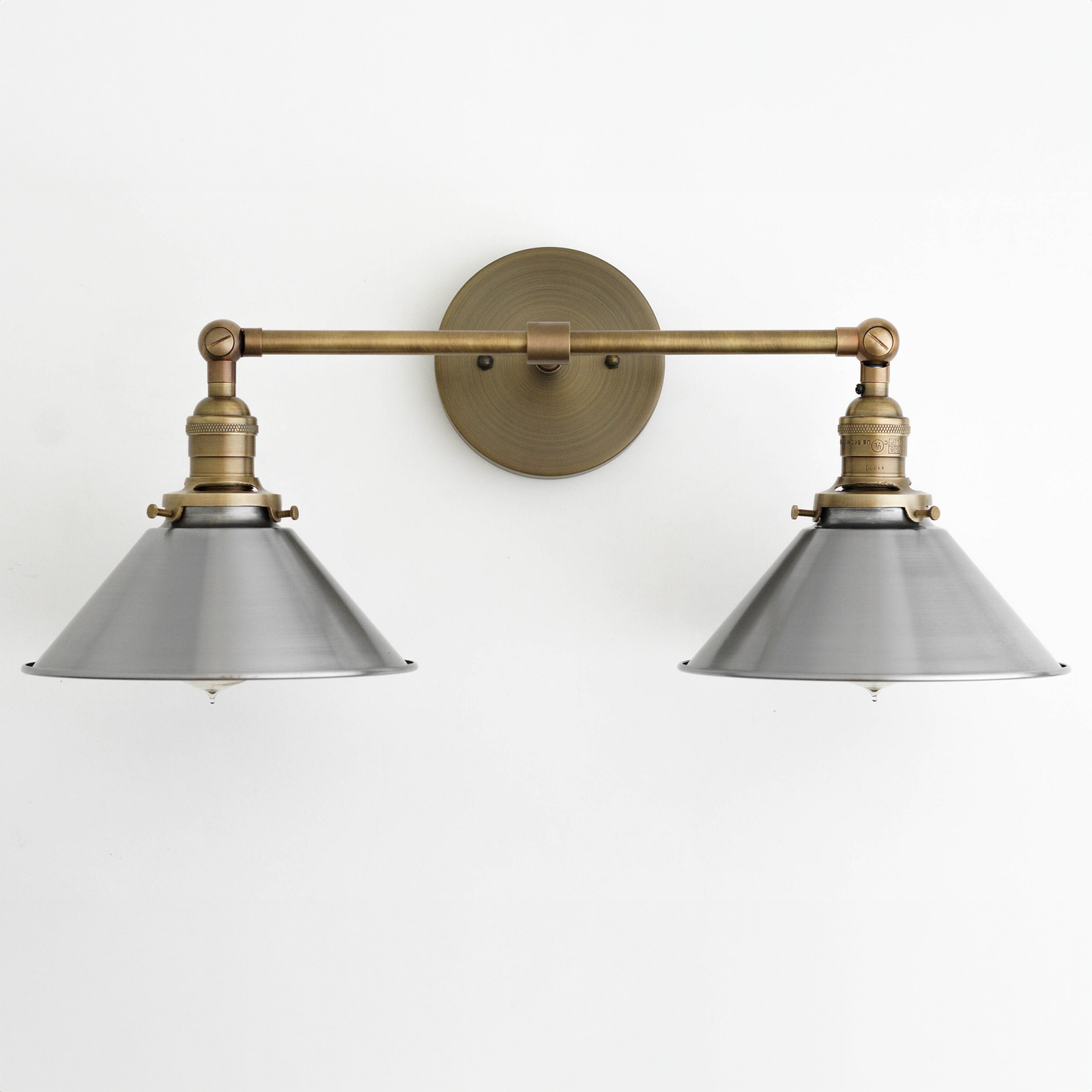 Industrial-style two-bulb vanity light with antique brass finish and gray metal shades. - VANITY LIGHT MODEL NO. 0799